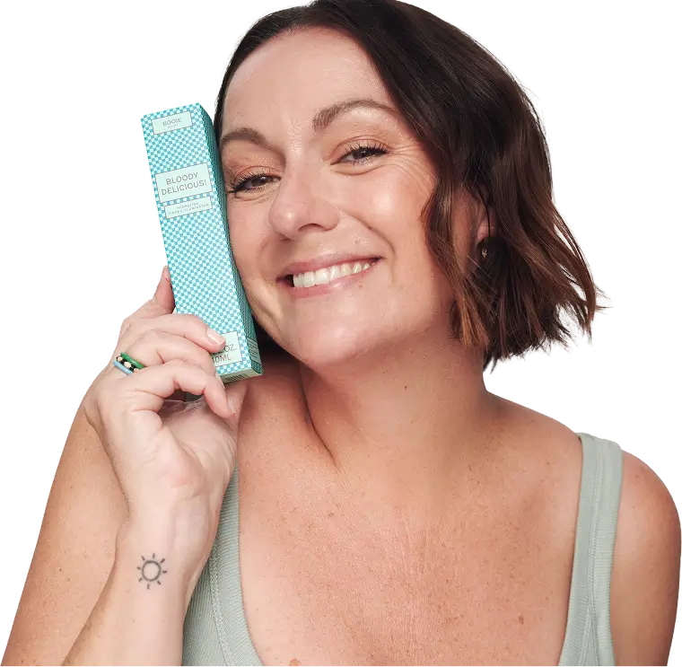 Celeste smiling with Booie product in hand