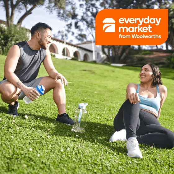 Everyday Market from Woolworths - 2 people in active wear relaxing in park with water bottles